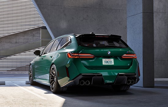 Green BMW M5 Touring parked in garage. | BMW Showcase 1 in Derwood MD