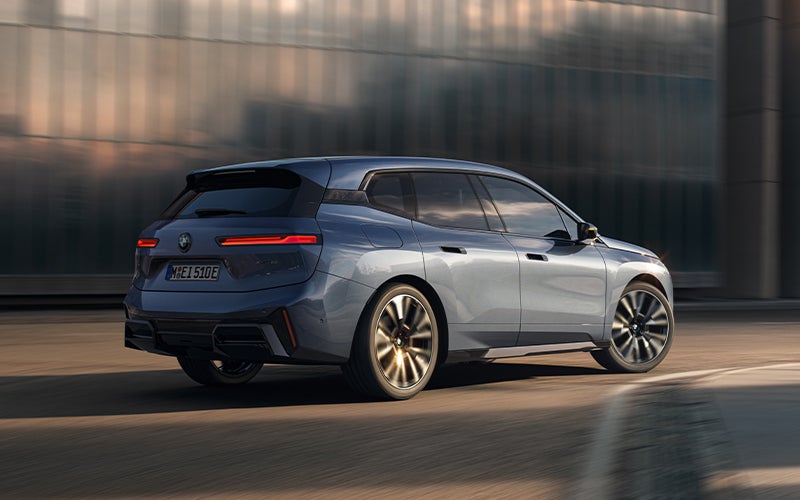 The BMW iX driving with the front wheel turned. | BMW Showcase 1 in Derwood MD